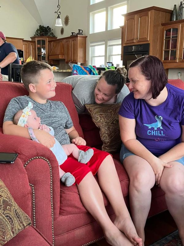 Teagan Holding a Friend's New Baby