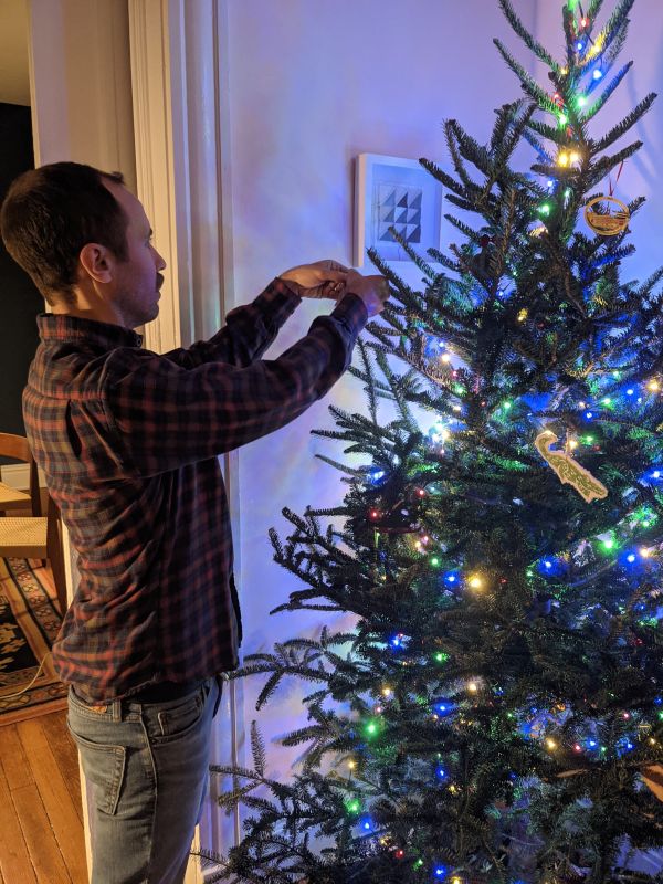 Chad Decorating the Christmas Tree With Ornaments From His Childhood