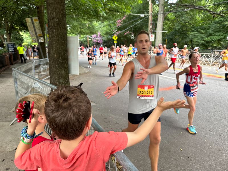 Matt Getting Encouraged by Our Nephew at a 10K