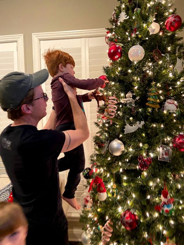 Bryan Decorating the Christmas Tree With Our Nephew